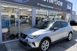 SEAT Arona 2024 gris GRS en 3/4 avant droit, avec jantes alliage 16 pouces et calandre noire satinée.