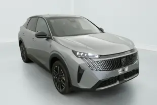Peugeot 3008 1.2 Hybrid 145 GT gris, vue 3/4 avant avec calandre distinctive et phares LED allumés.