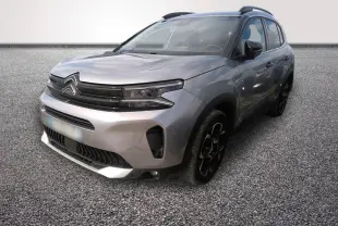 Citroën C5 Hybride gris clair vue 3/4 avant droit avec calandre noire et jantes noires distinctives.