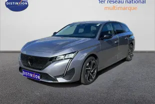 Peugeot 308 SW Hybrid gris Artense métal vue 3/4 avant droit avec jantes alliage et calandre noire distinctive.