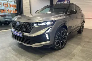 Renault Austral 2025 gris schiste métallisé avec toit noir étoilé, vue 3/4 avant droit mettant en valeur la calandre et les phares LED.